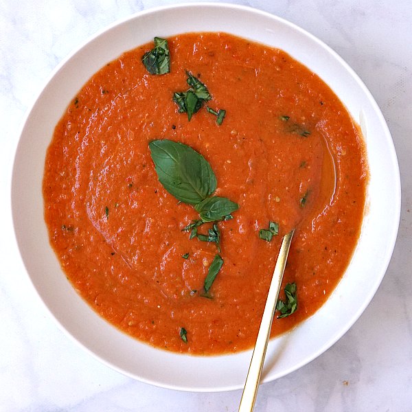 A bowl of fresh tomato basil soup made from fresh tomatoes and bell pepper.