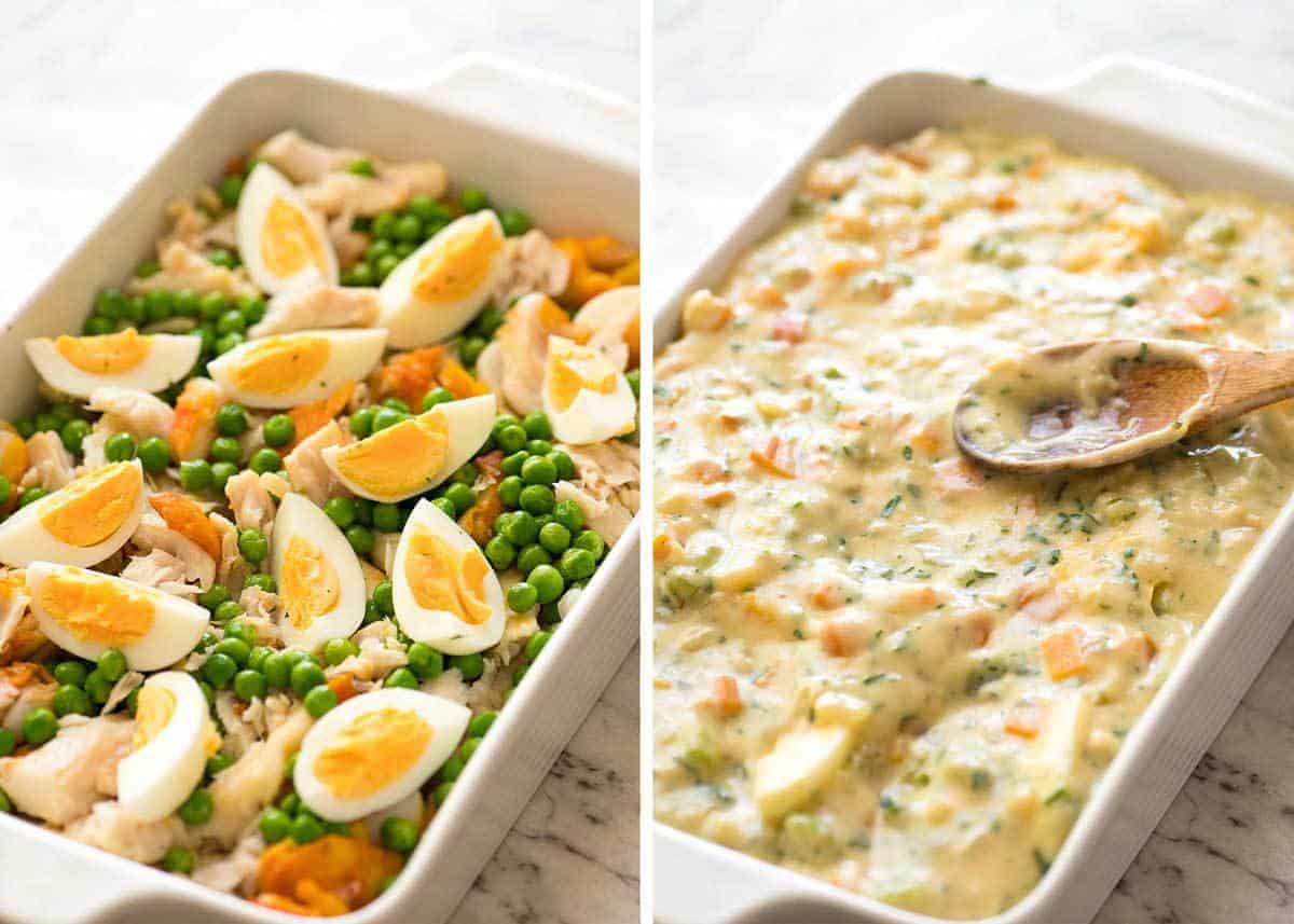 Fish pie filling in white baking dish with creamy white sauce